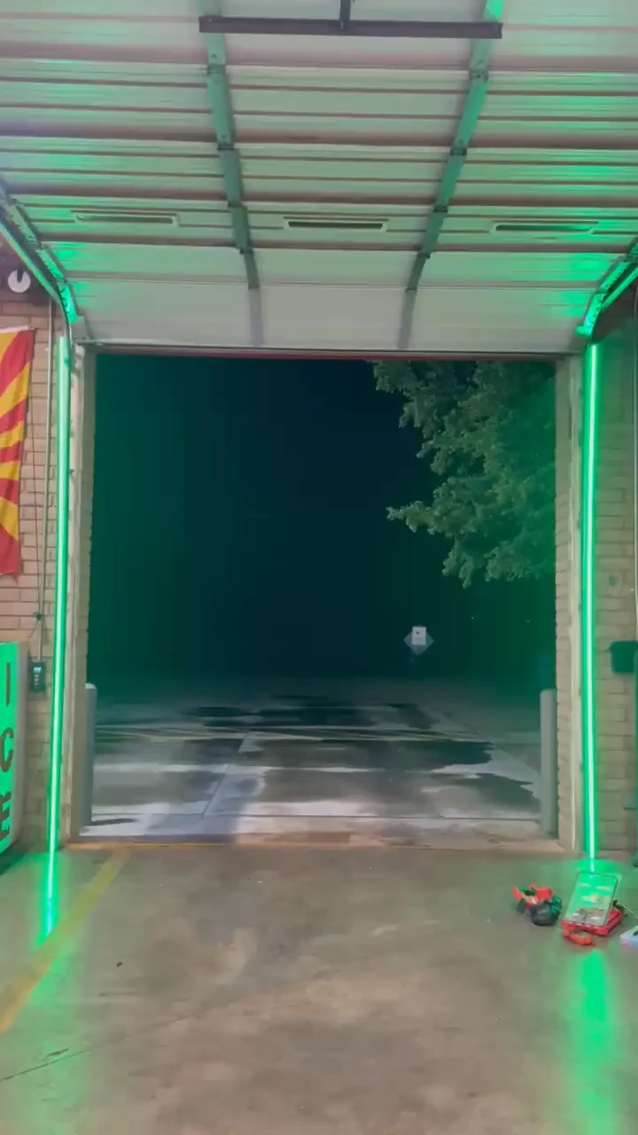 Green LED bars alongside the open overhead door